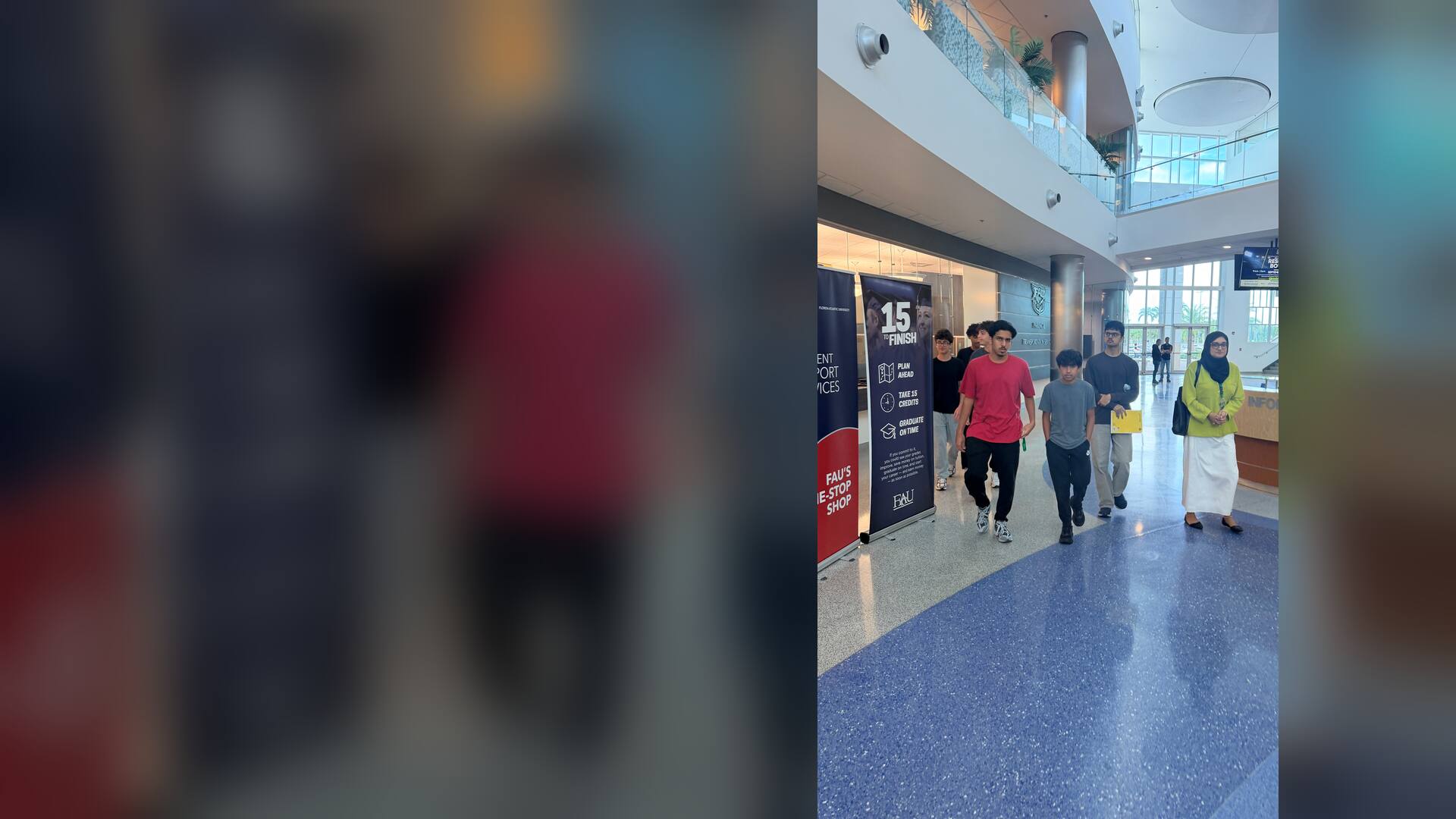 The group walking through a sunlit campus atrium