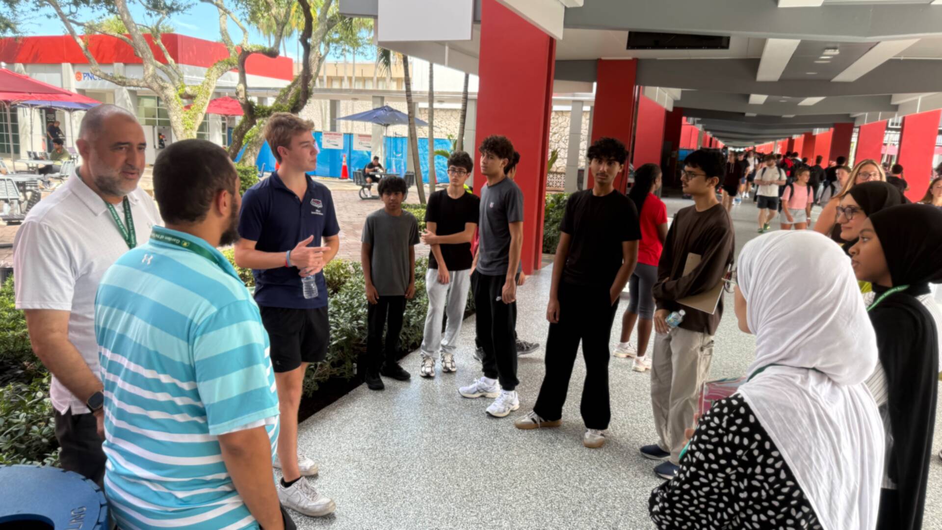 The group gathered with a tour guide along a covered walkway