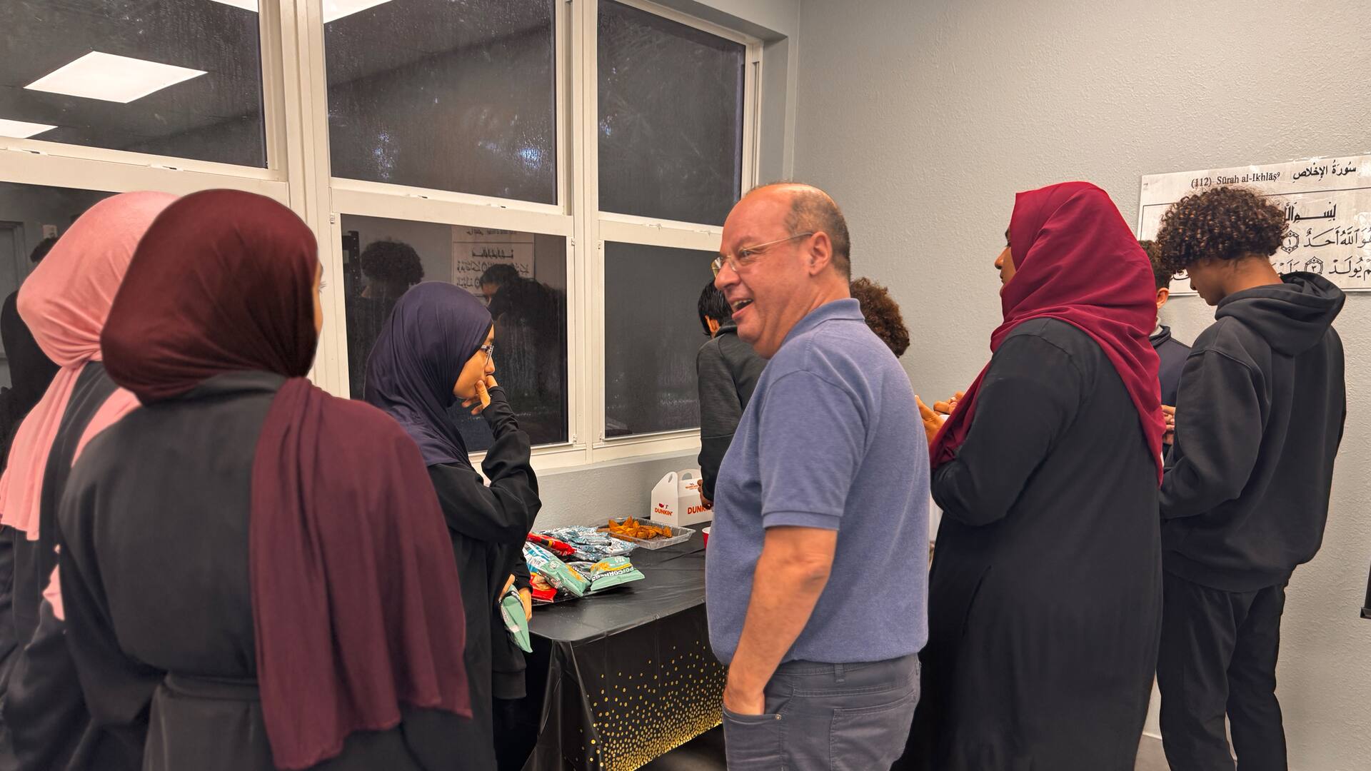A guest sharing a laugh with students after the session