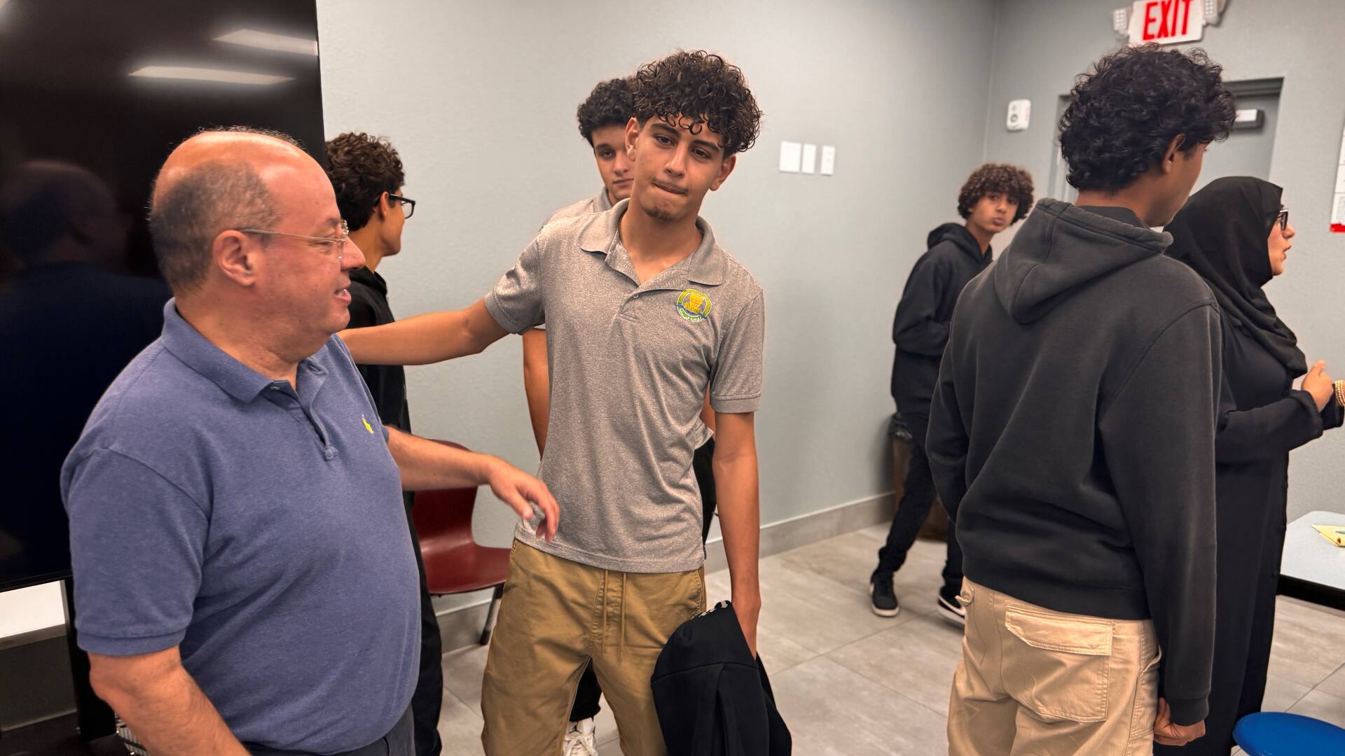 Students chatting with a guest after the presentation