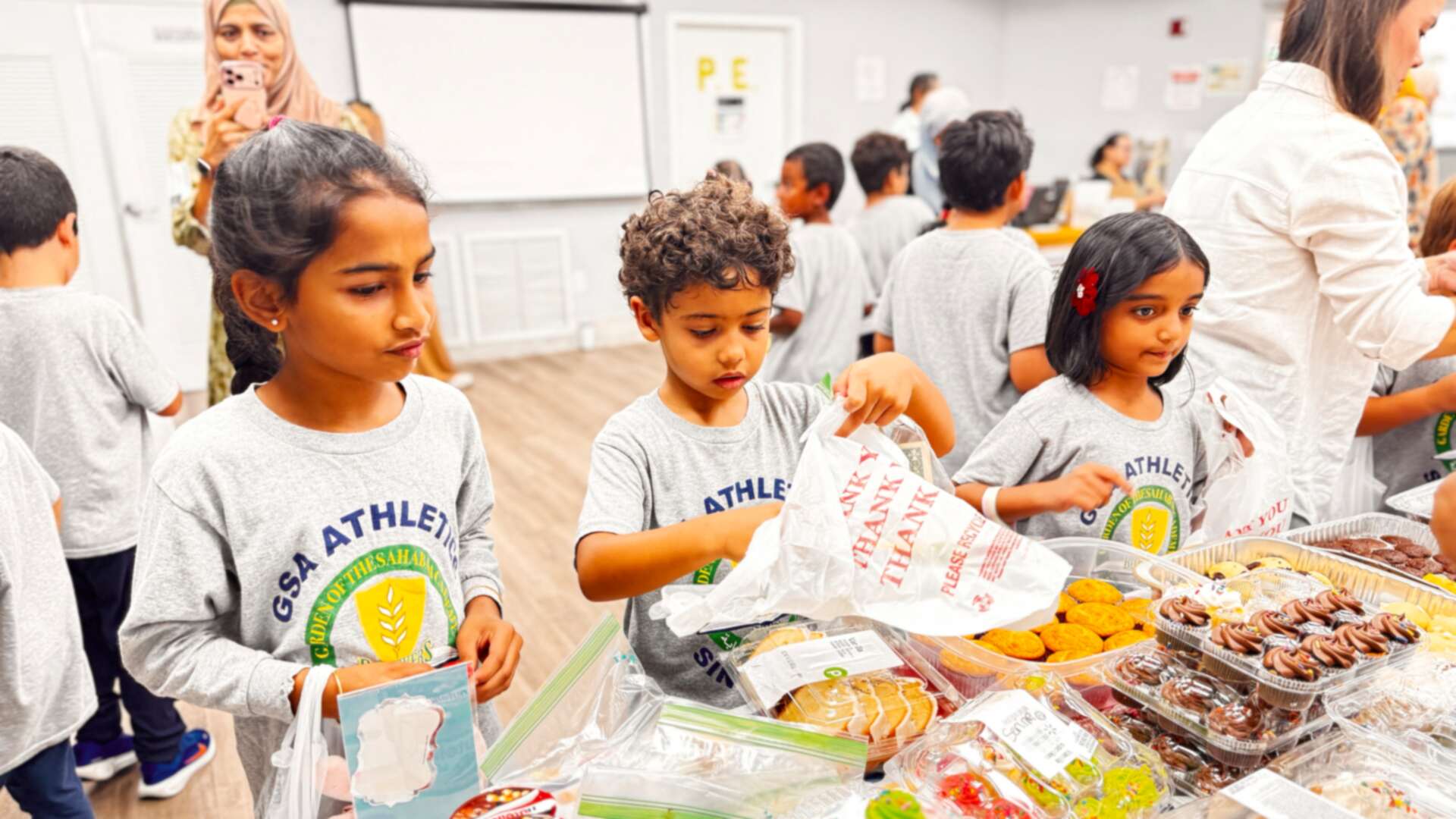 Students take their time choosing from cupcakes, cookies and sweets