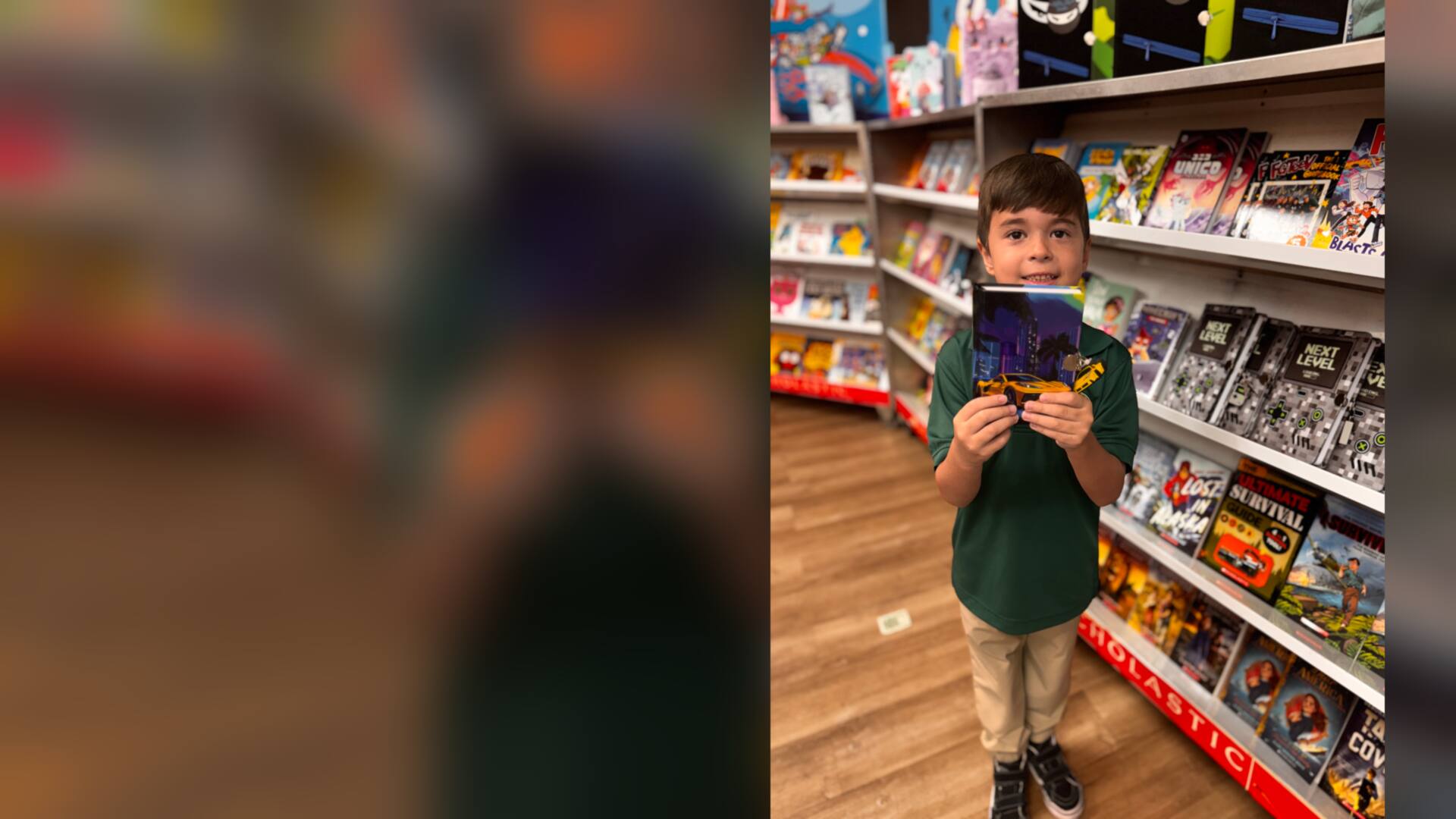 A student proudly holding up a chosen book by the shelves