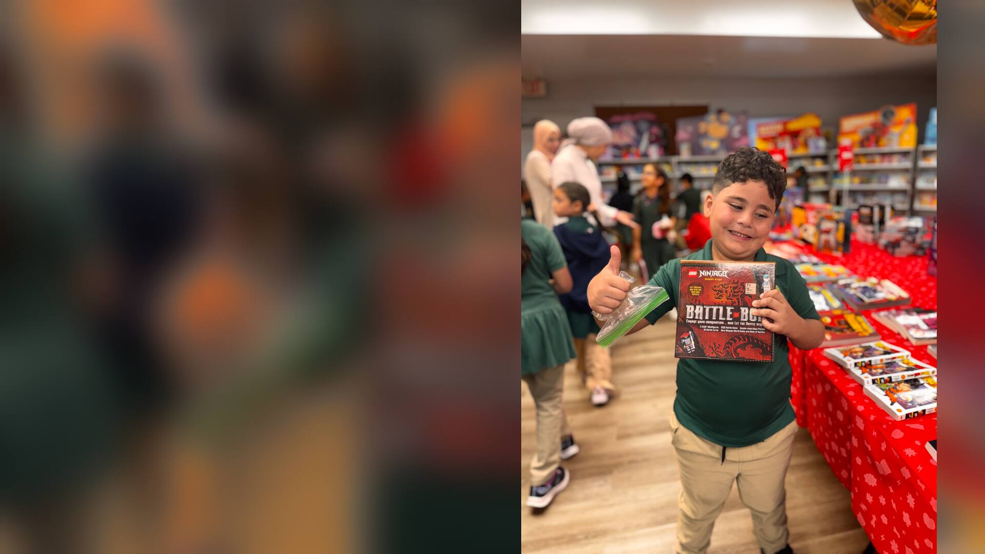 A student giving a thumbs-up with a new activity book