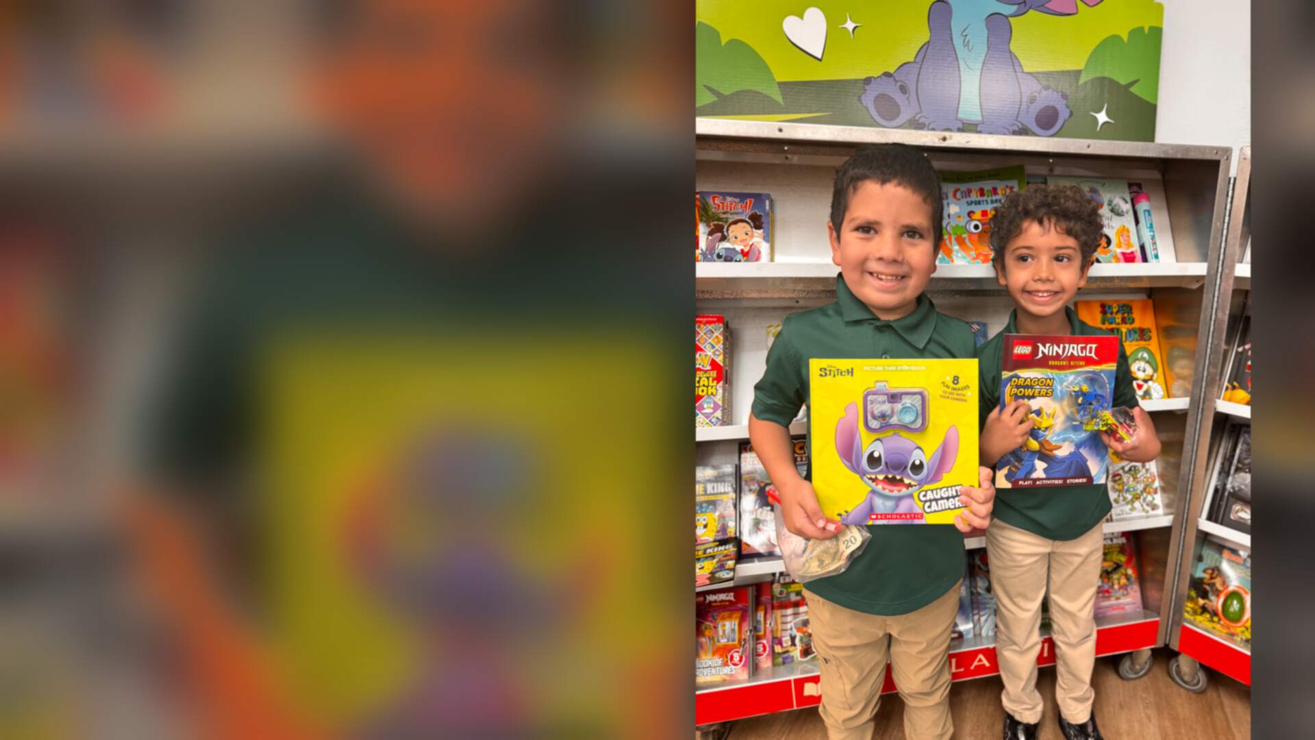 Two smiling students showing their new books