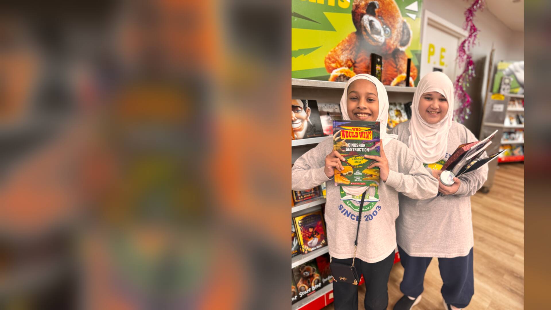 Two students showing off the books they picked