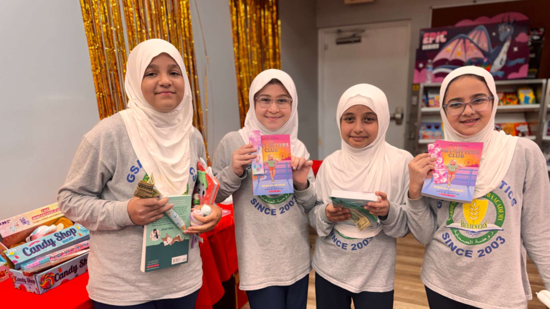 Four friends posing with their new books