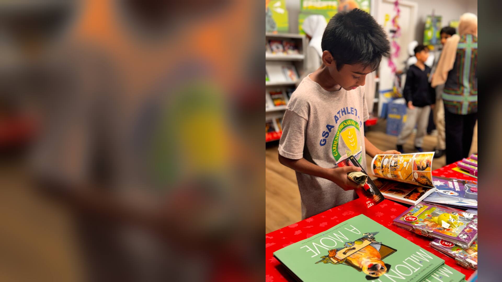 A student flipping through a comic book at the fair table