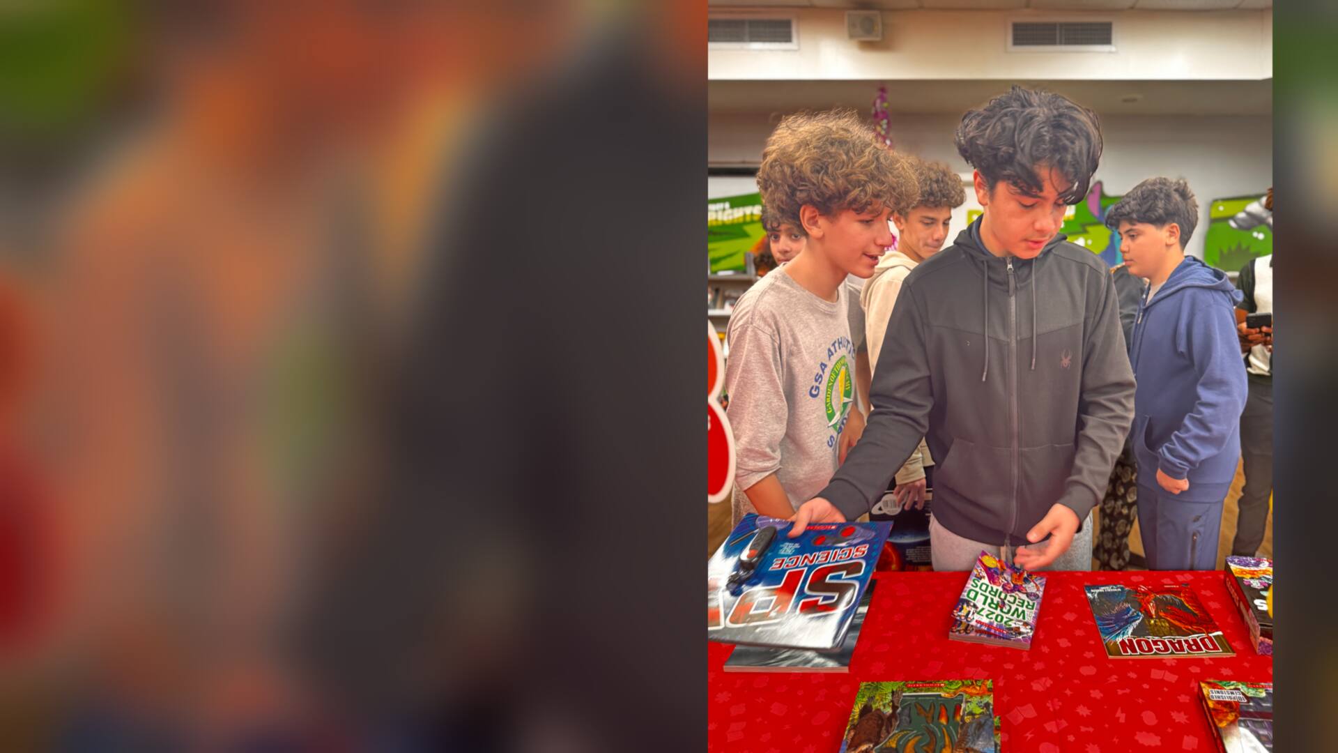 Students browsing books at the fair table
