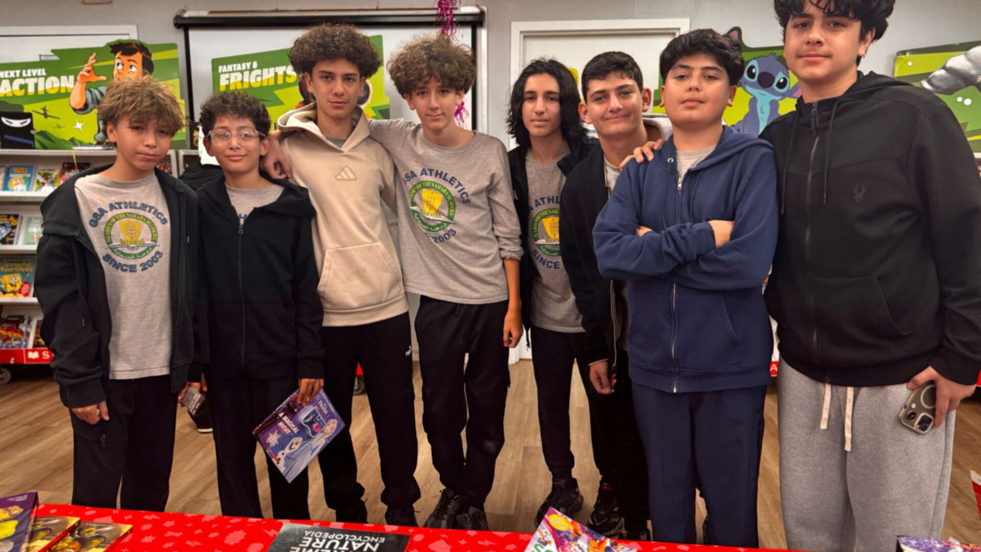 A group of students posing together at the book fair
