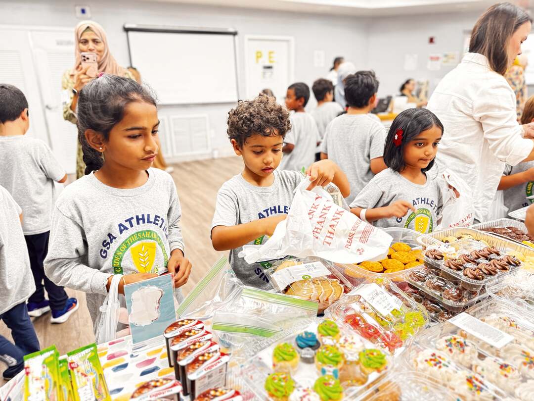 Students take their time choosing from cupcakes, cookies and sweets