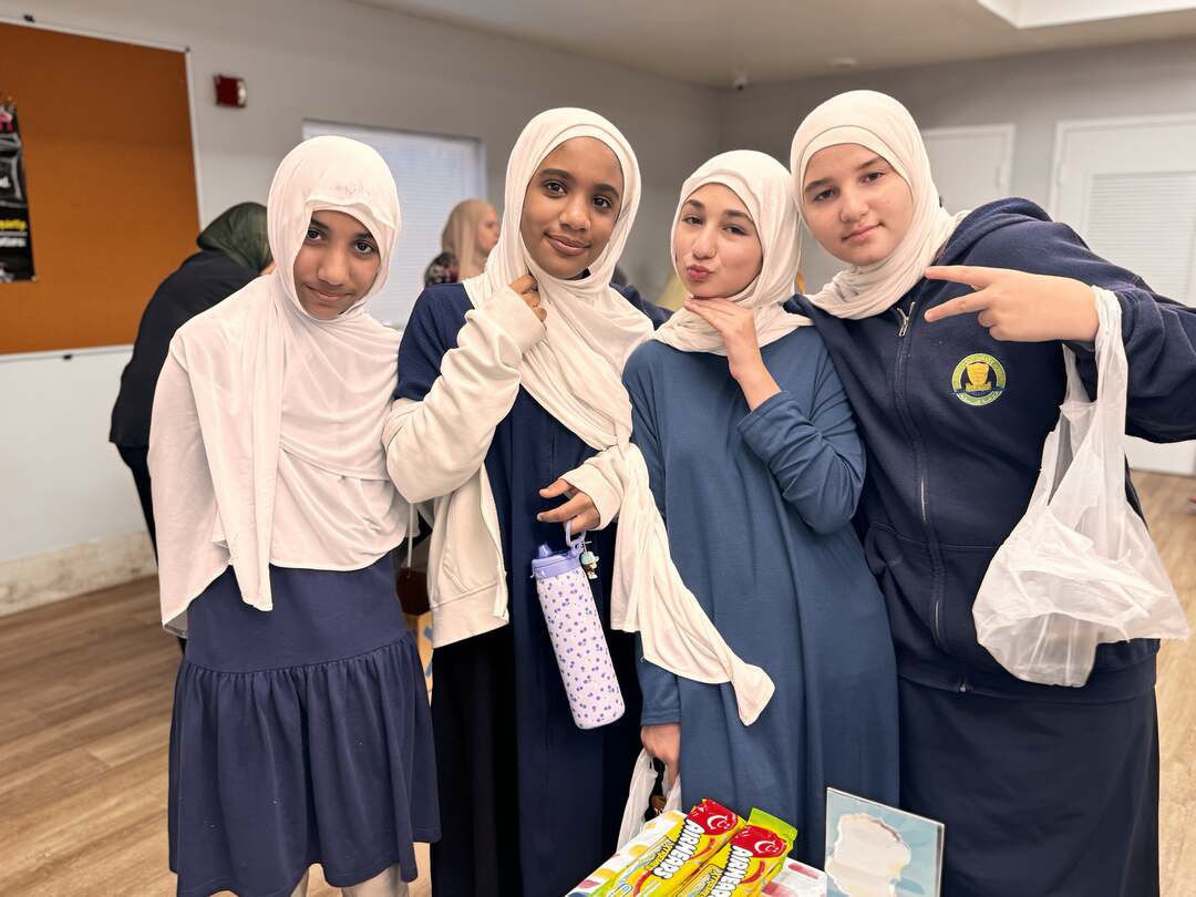 Four friends strike playful poses with their treats