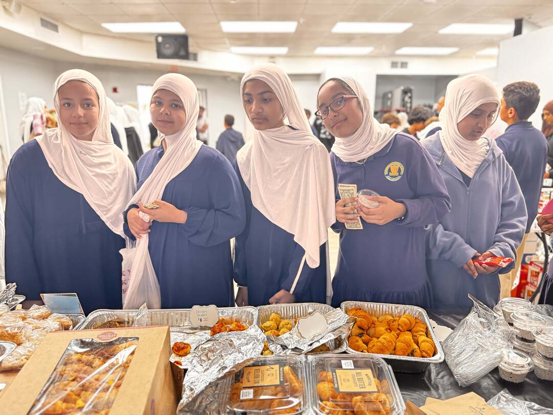 Older students holding cash smile while waiting at the savory table