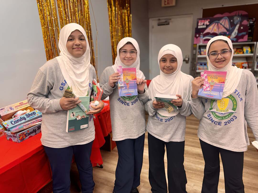 Four friends posing with their new books