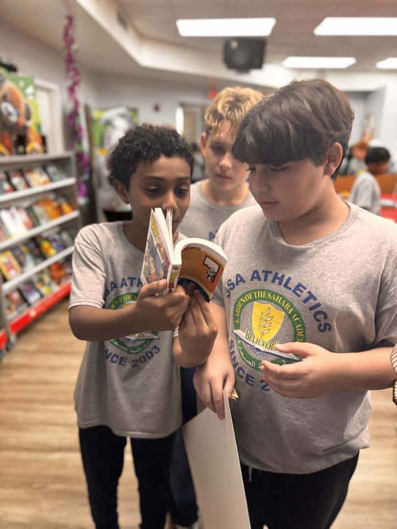 Students looking at a book together