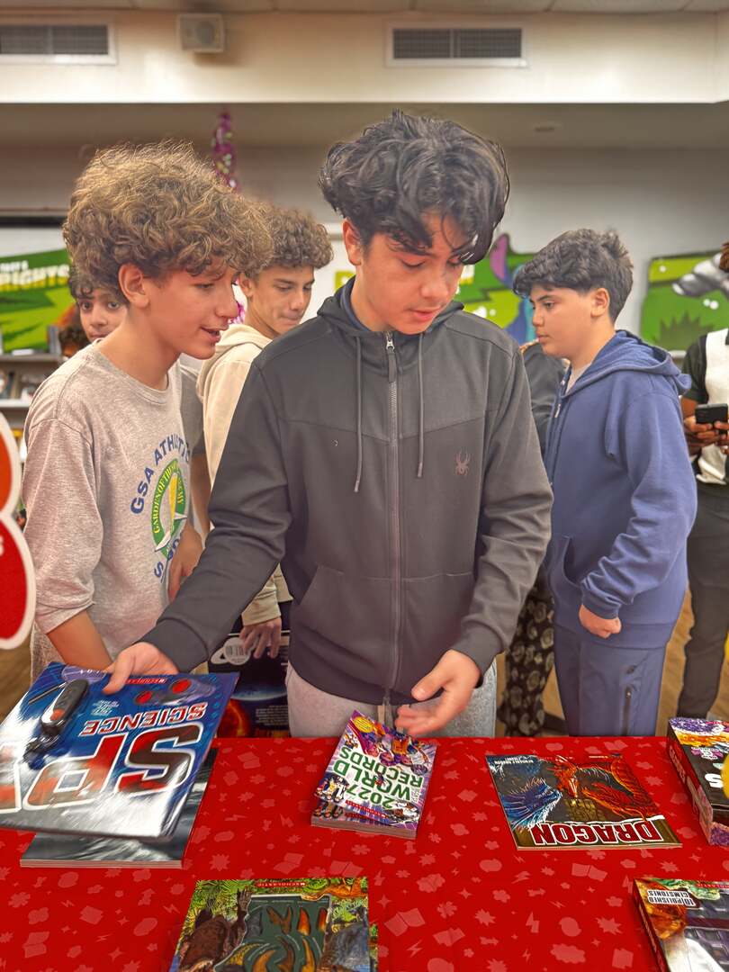 Students browsing books at the fair table