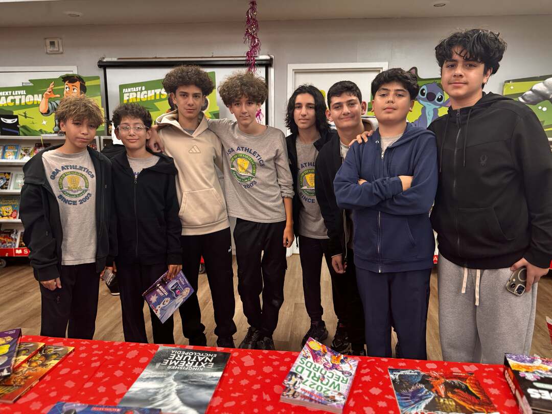 A group of students posing together at the book fair