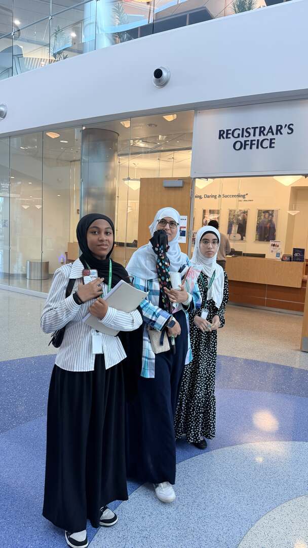 Visitors with tour folders outside the Registrar's Office