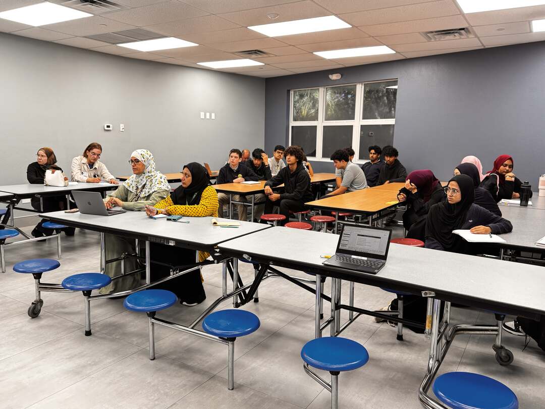 Families and students seated across the room, ready for the presentation