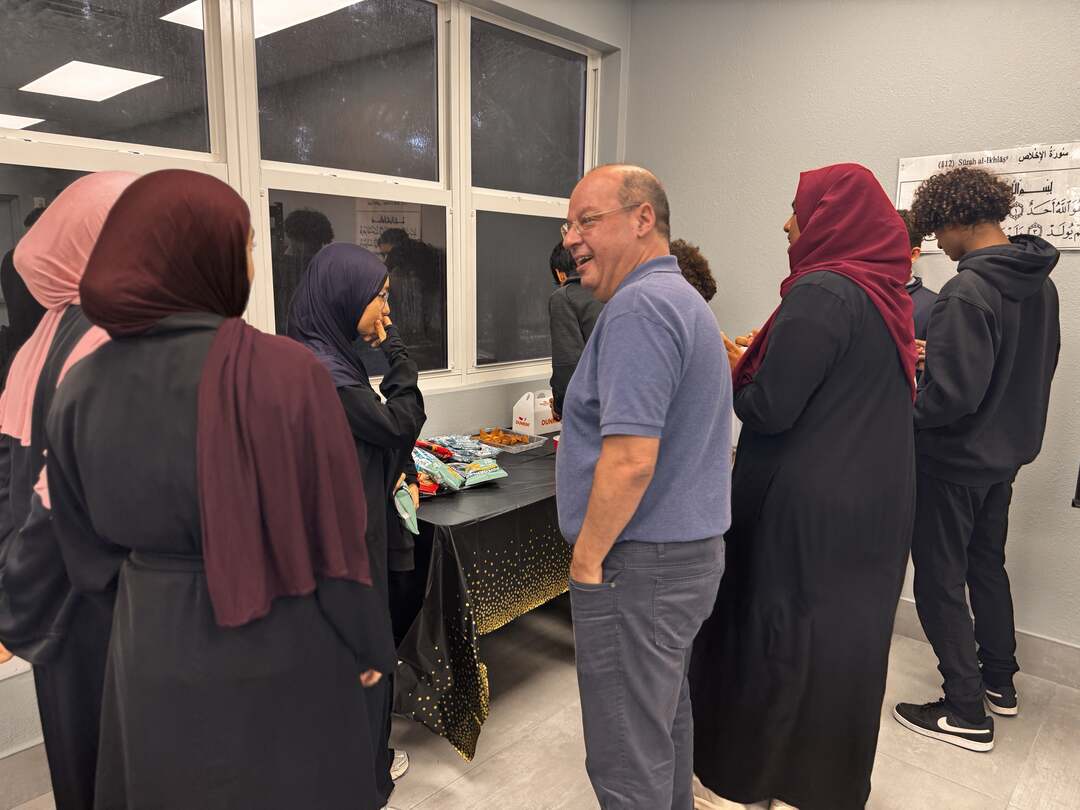 A guest sharing a laugh with students after the session