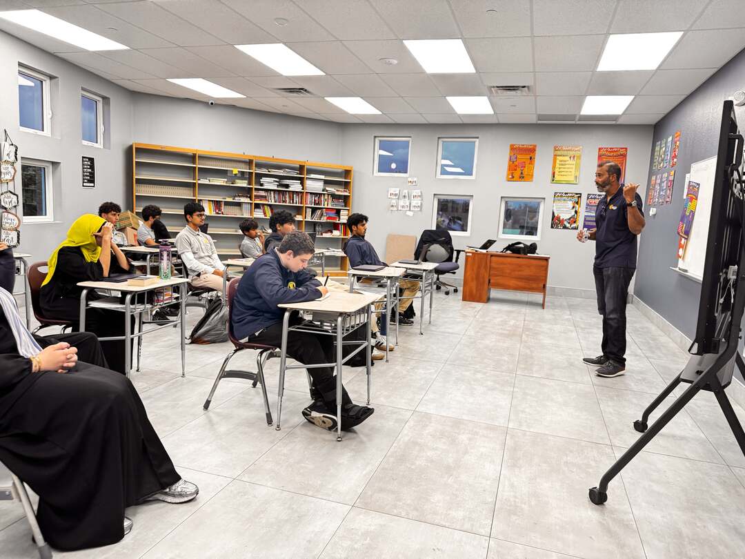 Our guest speaker gesturing while explaining a point to the class