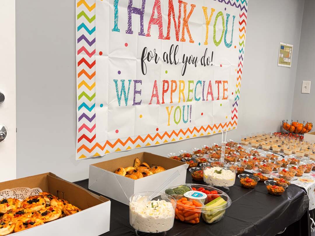 The breakfast spread laid out beneath the thank-you banner